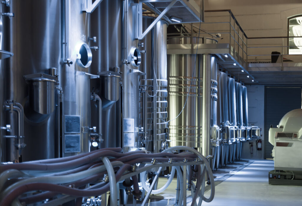 alt="Equipamentos industriais metálicos, exemplo de aplicação da caldeiraria industrial no setor alimentício